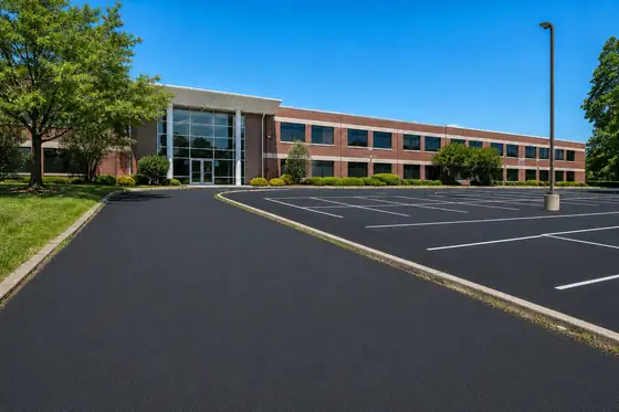 Suburban office building driveway after sealcoating