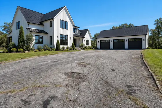 Modern farmhouse · three-car court driveway before sealcoating