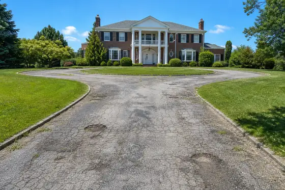 Brick colonial with circular drive driveway before sealcoating